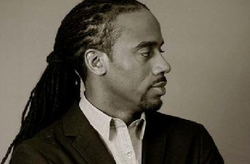 Man with dread locs in suit